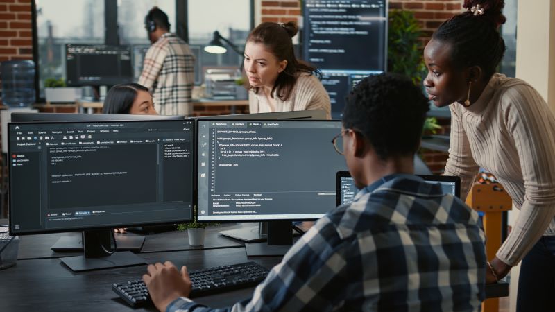 people at screens in office - AI applications such as ChatGPT are already a hot topic for marketers and are only going to become more so