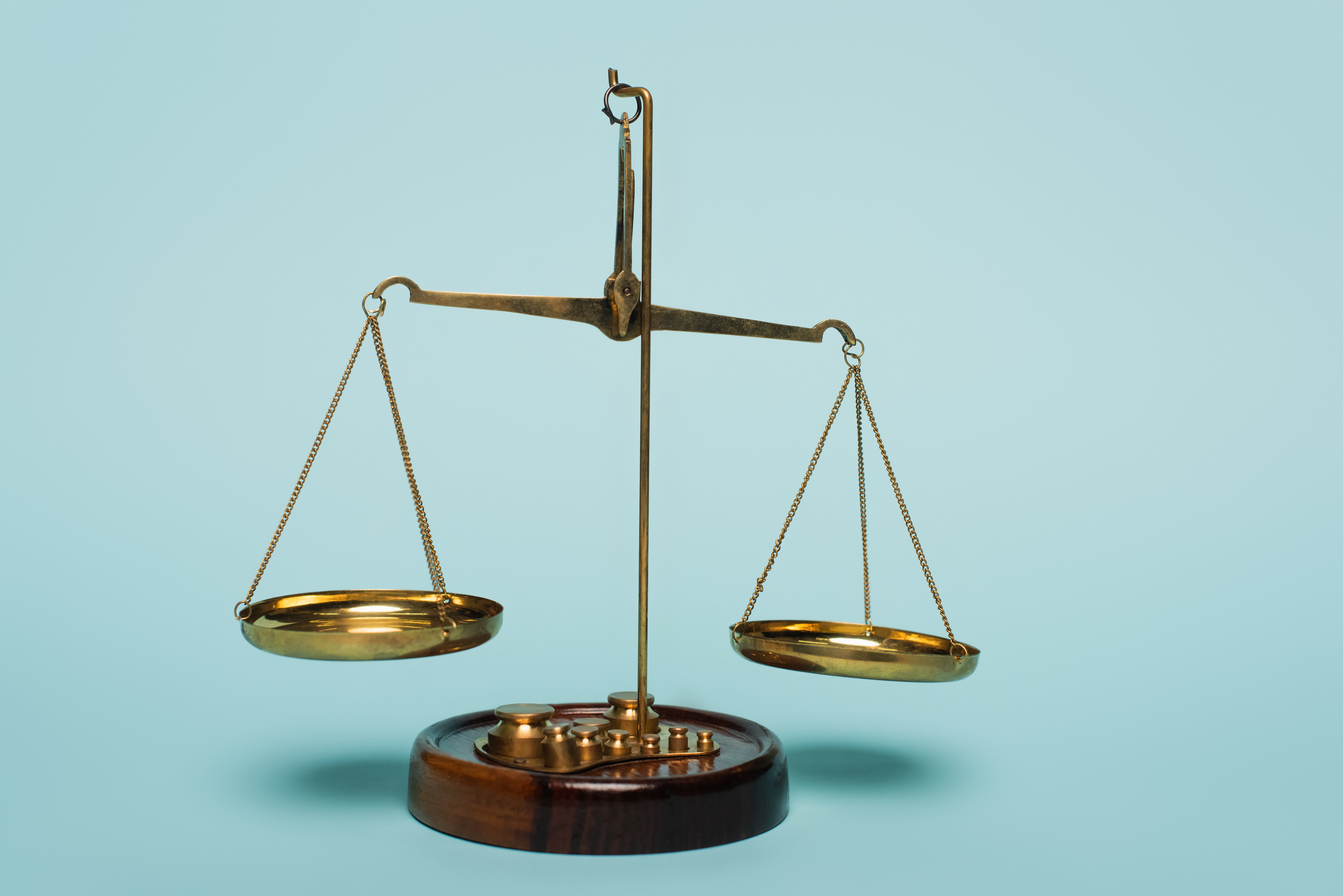 bronze-justice-scales-on-blue-background-anti-cor-2023-11-27-04-50-34-blog